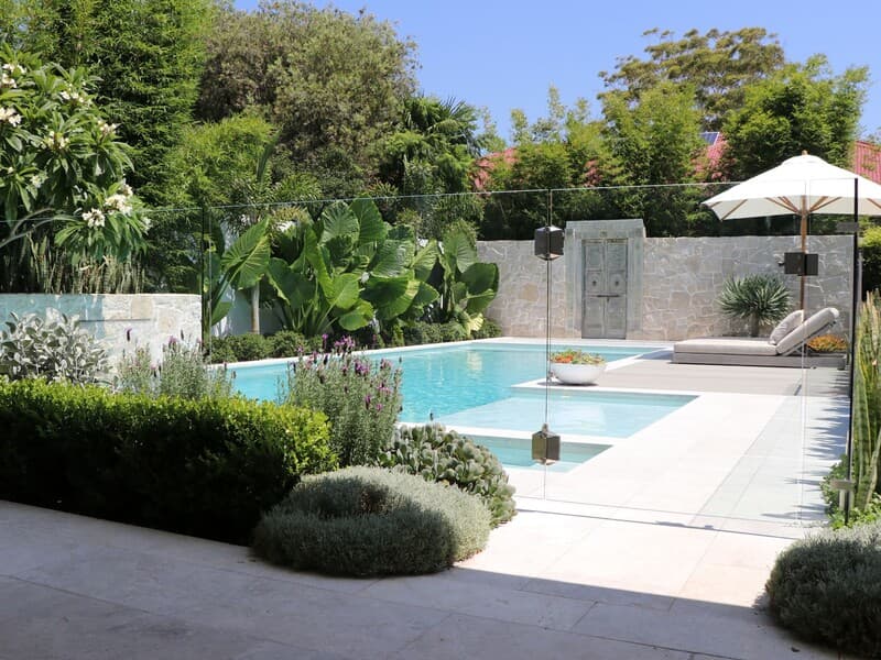 Natural pool landscaping with native plants and stone features in Sydney