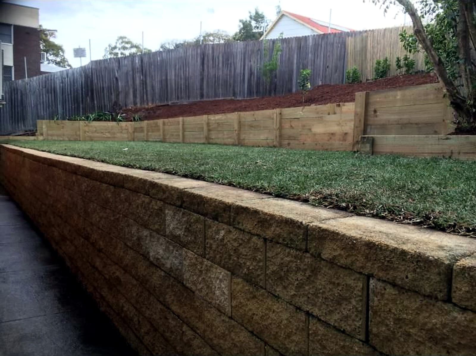 Completed lawn and timber sleeper retaining wall in Ermington by Nazscapes